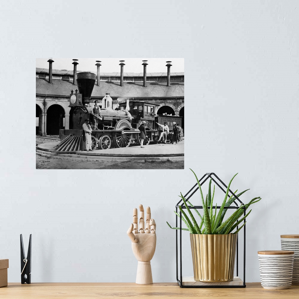 A bohemian room featuring Men turn the Great Western Railway steam locomotive No. 4. in 1859. The locomotive is mainly Brit...