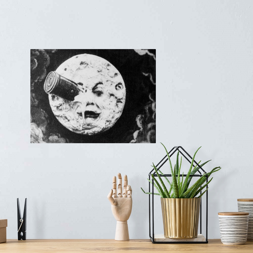A bohemian room featuring Depiction of Man in the Moon with a rocket in his eye from the 1914 silent animated film A Trip t...
