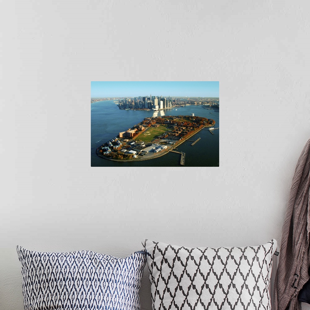 A bohemian room featuring New York Harbor and Manhattan  with Governors Island in the foreground.
