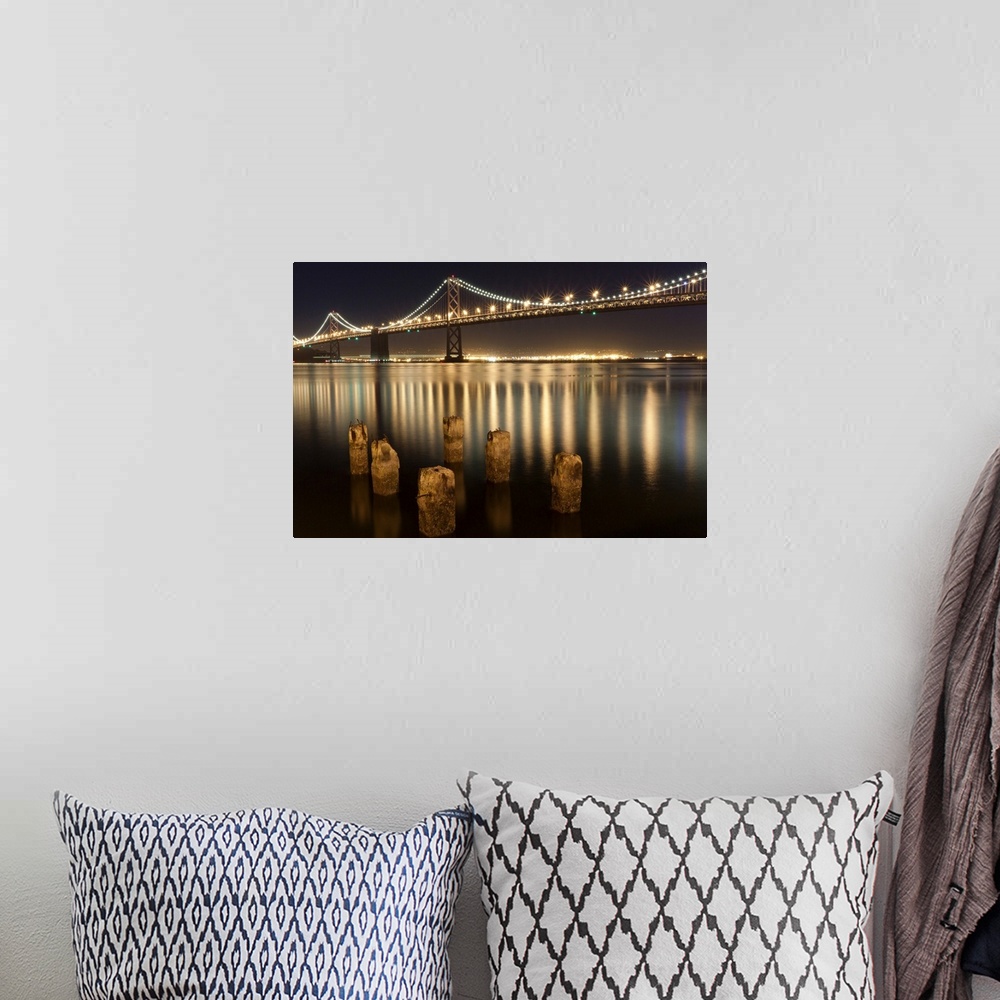 A bohemian room featuring Oakland Bay Bridge night reflections.