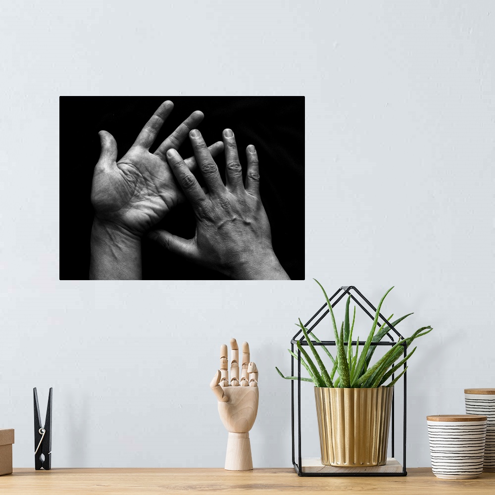 A bohemian room featuring Human pair of hands on black background.