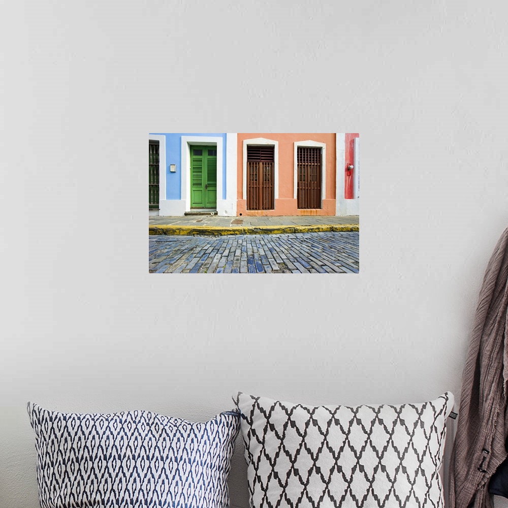 A bohemian room featuring This is a horizontal photograph of an urban landscape of doorways to colorful houses.
