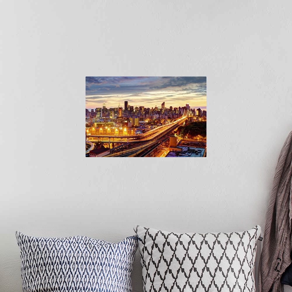 A bohemian room featuring Queensboro Bridge and Long Island City in Queens, with Midtown Manhattan as background. Sunset ho...