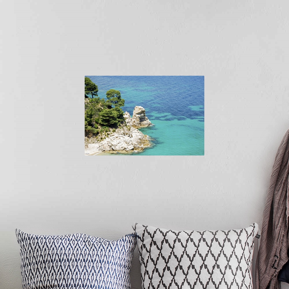 A bohemian room featuring Clear blue water, rock cliffs and Mediterranean pine trees on coast of Chalkidiki peninsula , Gre...