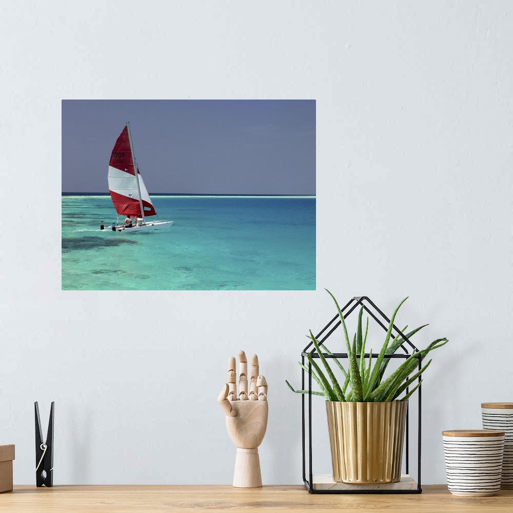A bohemian room featuring Sailboat on crystal blue water