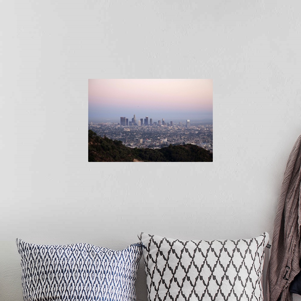 A bohemian room featuring Landscape view of skyscrapers of downtown LA with hills of Griffith Park in foreground as seen at...