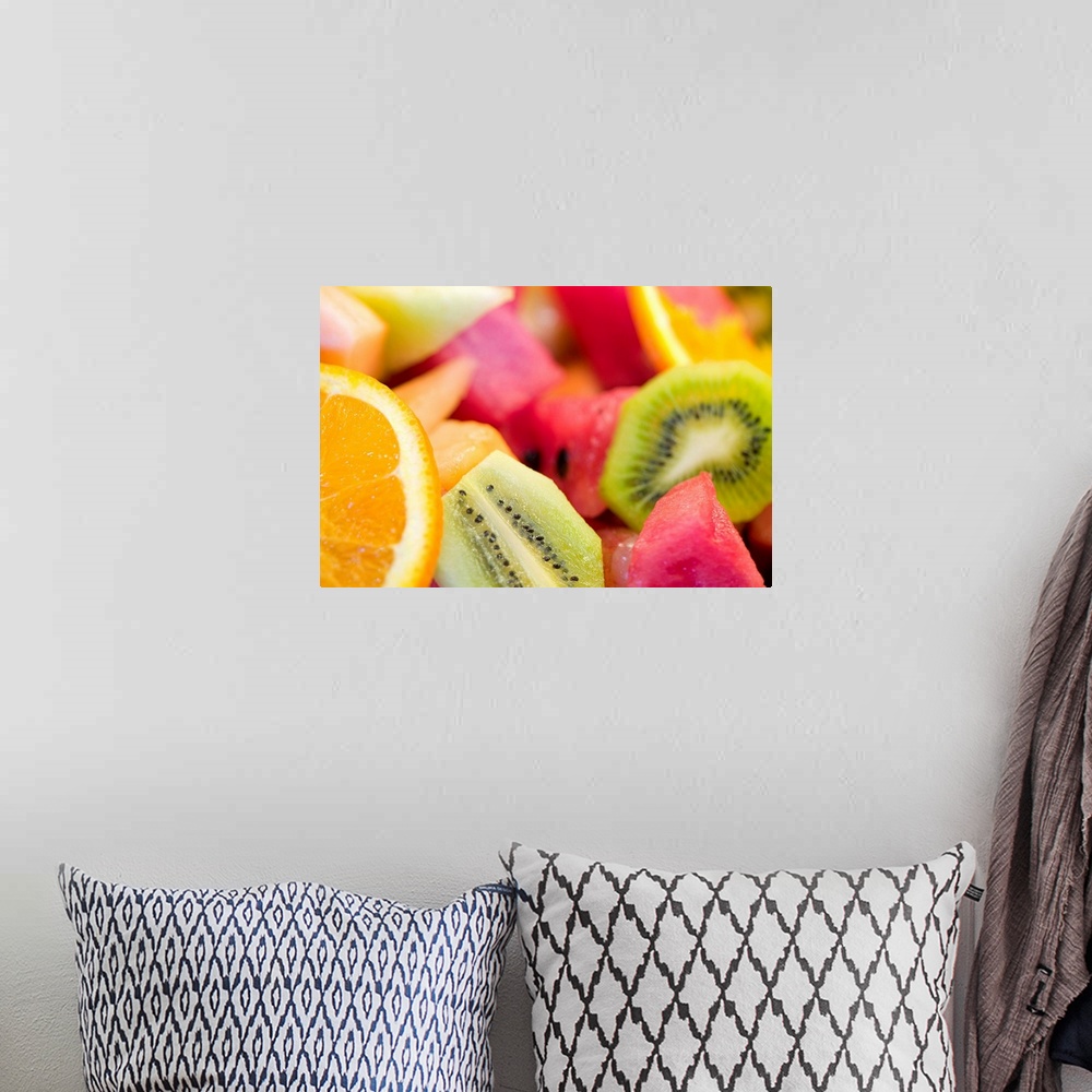 A bohemian room featuring Photograph of cut oranges, kiwi, watermelon, and cantaloupe.