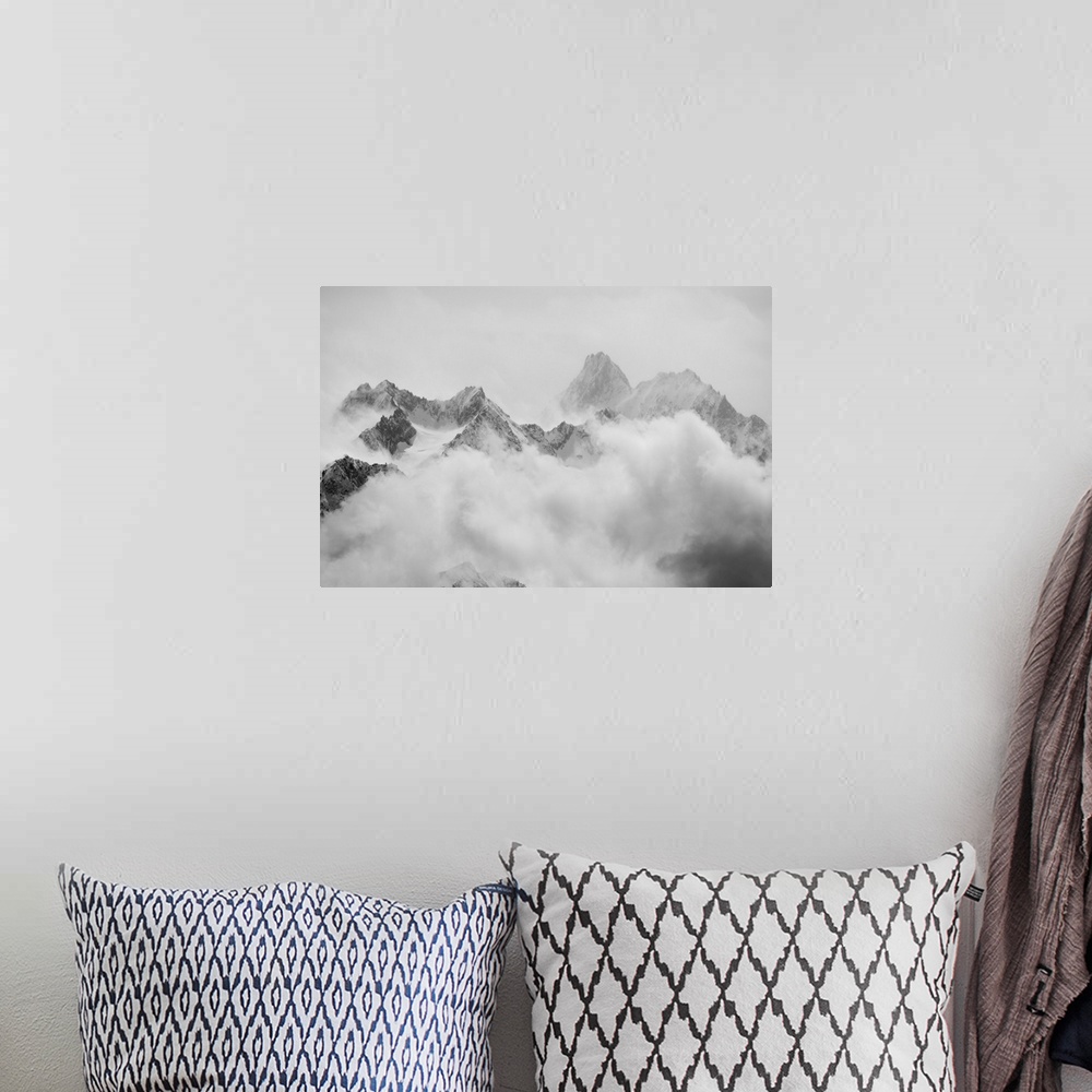 A bohemian room featuring Atmospheric clouds linger around the peaks of the Swiss alps after a spring snow storm.