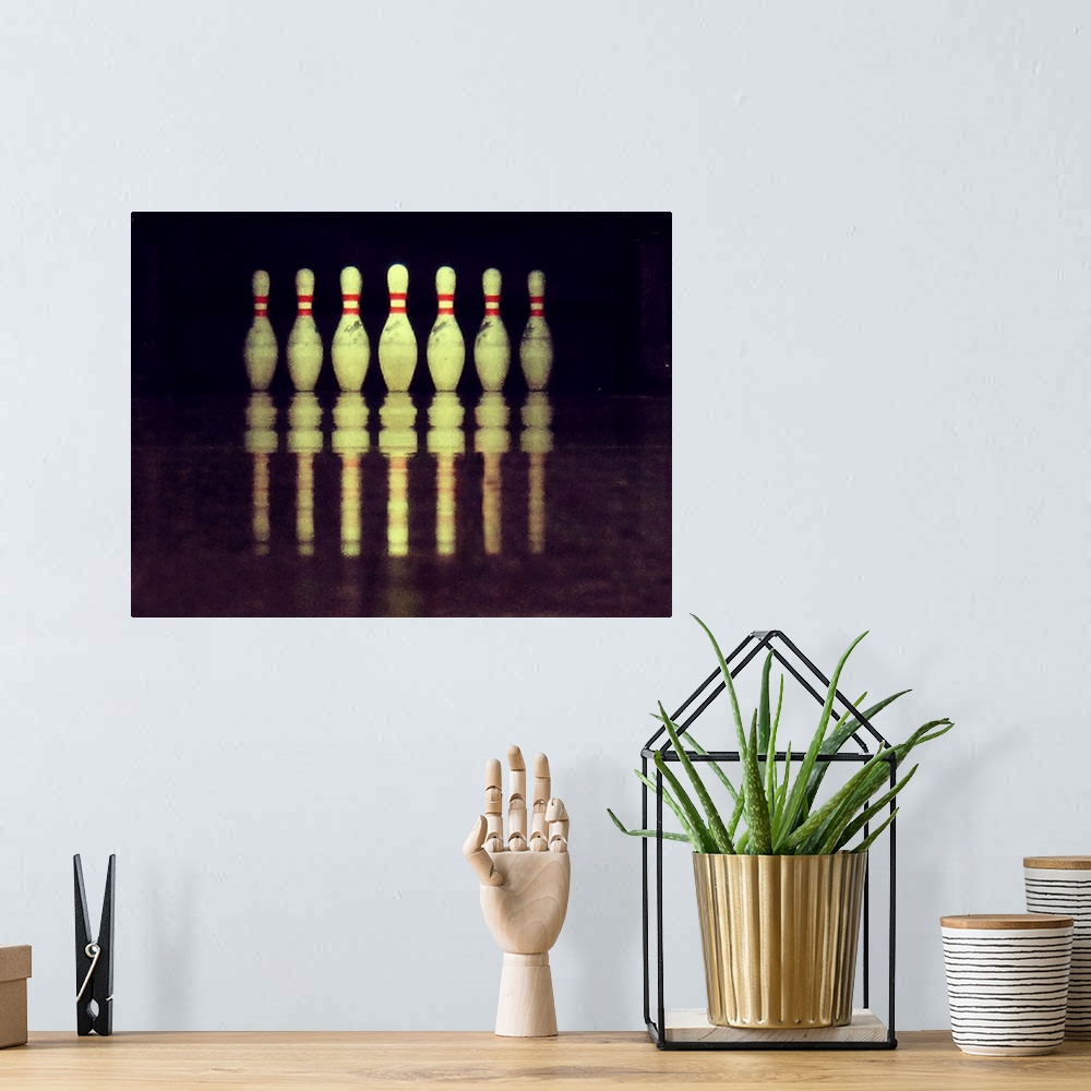 A bohemian room featuring Standing bowling pins with ground reflections.