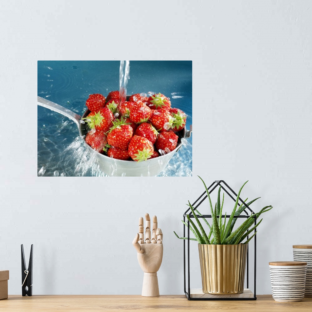 A bohemian room featuring Strawberries washing in sieve, close-up