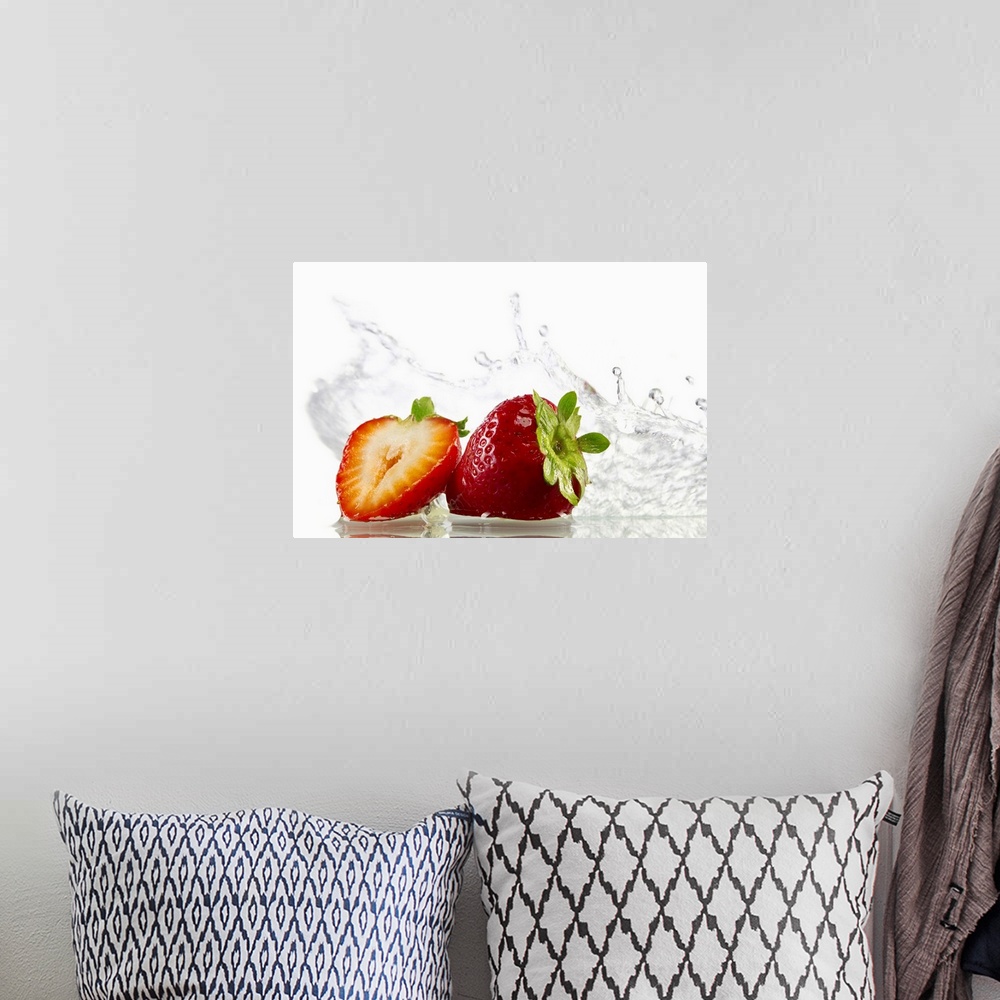 A bohemian room featuring Horizontal, photograph on large canvas of two strawberries, one cut in half, with water splashing...