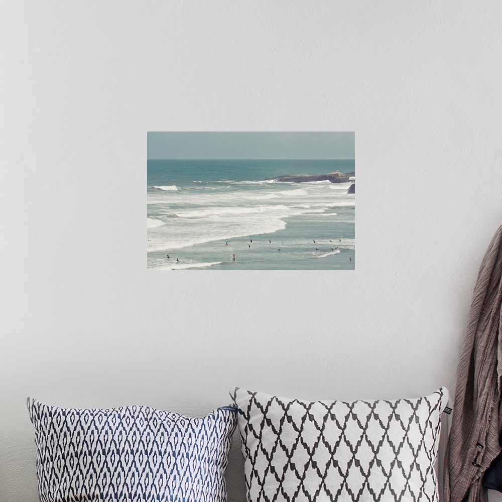 A bohemian room featuring Surfers lying in ocean.