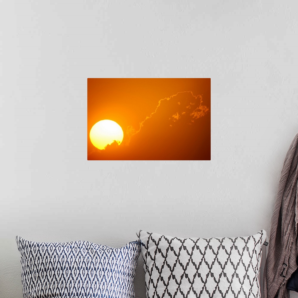 A bohemian room featuring Telephoto view of the rising sun behind orange clouds, Durban, Kwazulu-Natal, South Africa