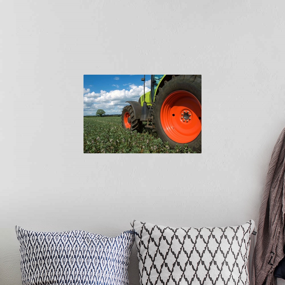 A bohemian room featuring Tractor driving through crops