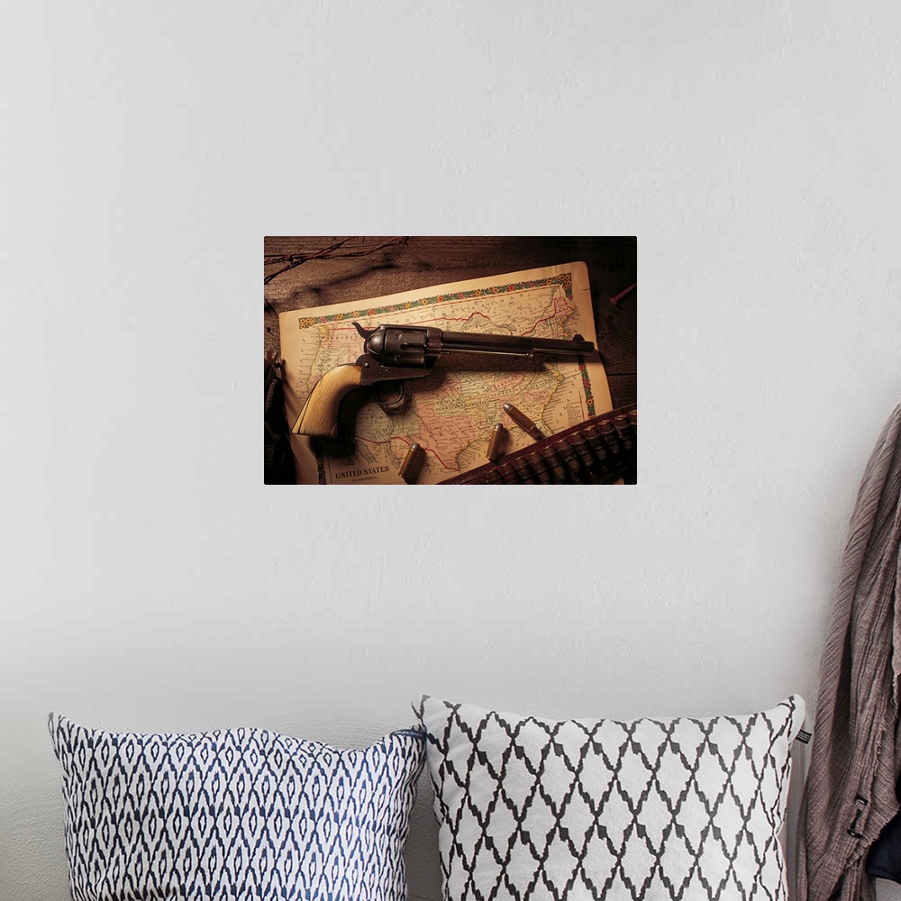 A bohemian room featuring Vintage revolver with bullets and map