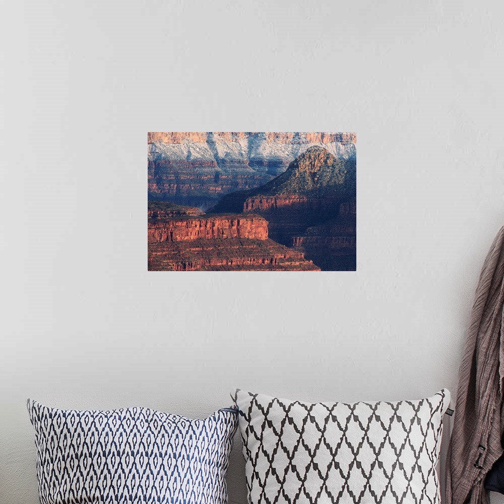 A bohemian room featuring Colorful bands show layers of sediment on the walls of the Grand Canyon in Arizona.
