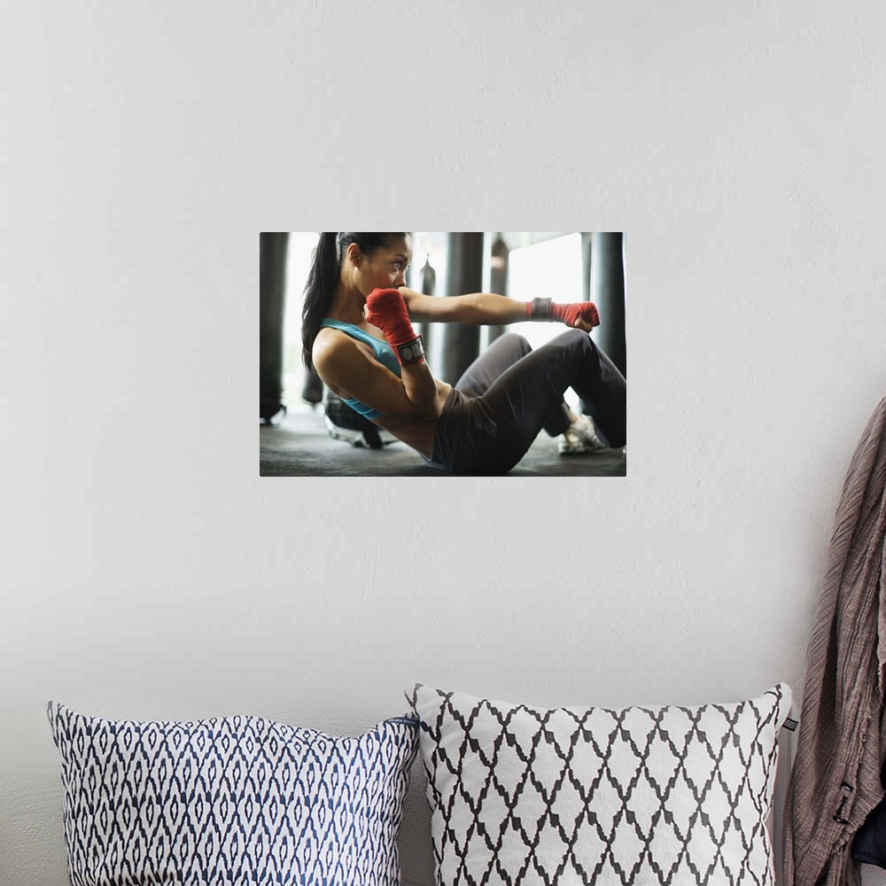 A bohemian room featuring Woman doing crunches in gym