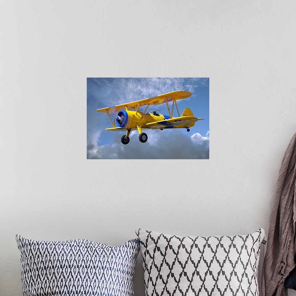 A bohemian room featuring Yellow Stearman 5YP bi-plane flying in cloudy sky