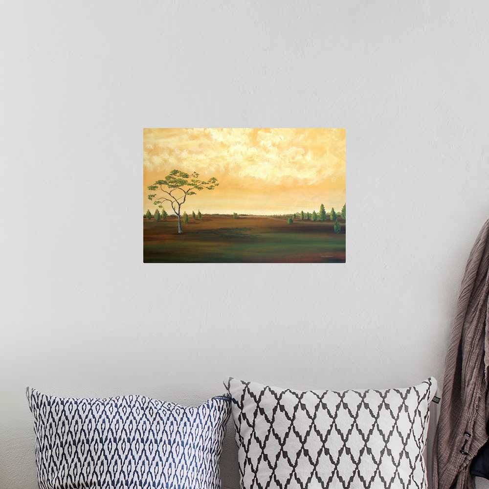 A bohemian room featuring Contemporary landscape painting of a countryside with a few trees and a golden sky.