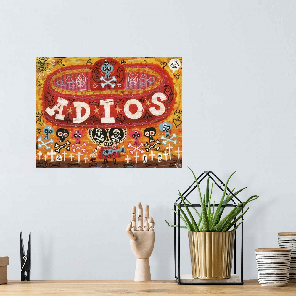 A bohemian room featuring Latin art of a calavera wearing a large red sombrero with the word "Adios."