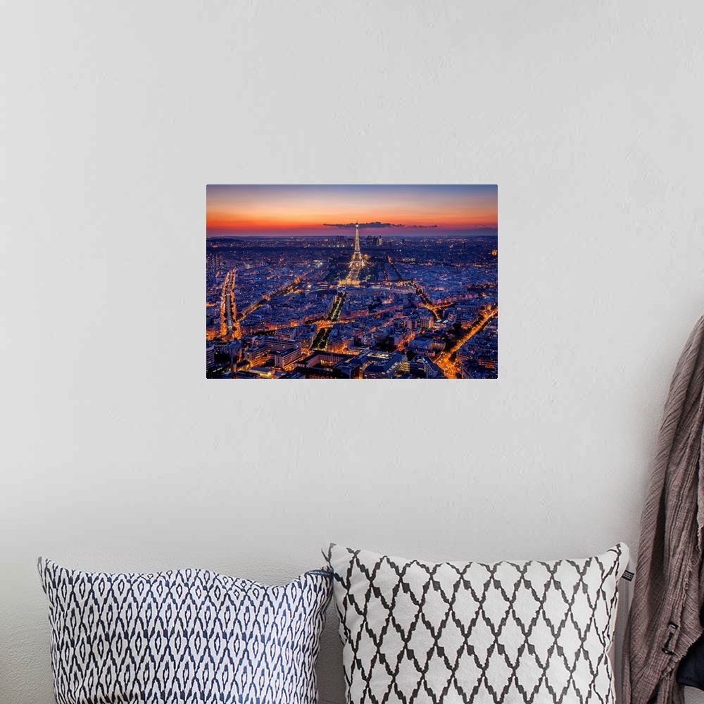 A bohemian room featuring An aerial photograph of Paris at night with the Eiffel tower seen standing tall.
