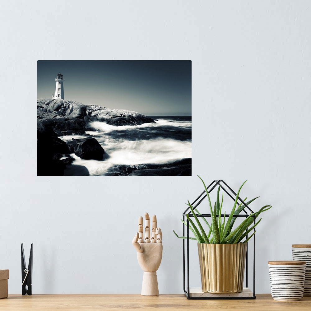 A bohemian room featuring A black and white image of Peggy's Cove Lighthouse in Nova Scotia, Canada.
