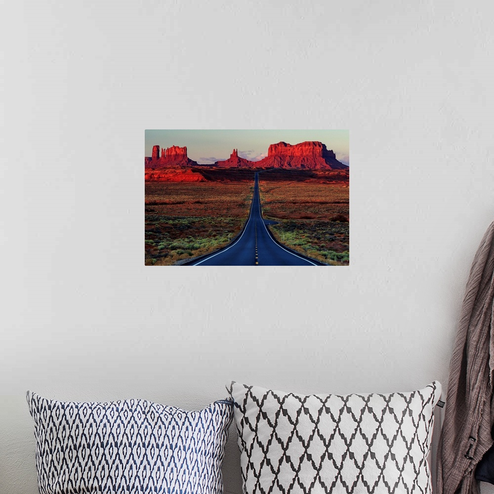 A bohemian room featuring Photograph of a road dividing the Arizona and Utah deserts.