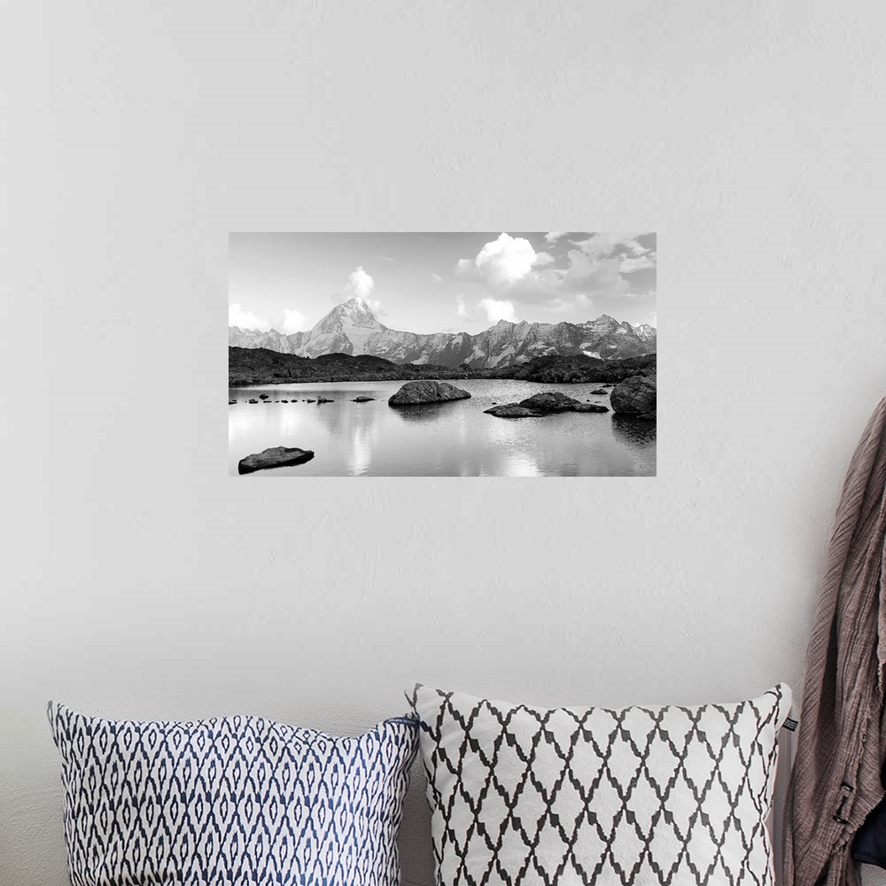 A bohemian room featuring Black and white landscape image of a lake with snow covered mountains in the background.