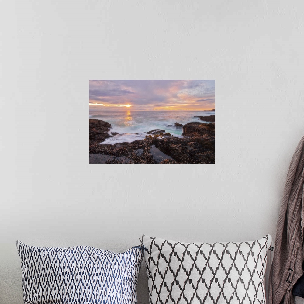 A bohemian room featuring A photograph of a seascape at sunset.