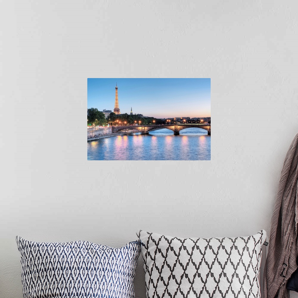 A bohemian room featuring A photograph of the Seine river in Paris with the Eiffel Tower in the background.