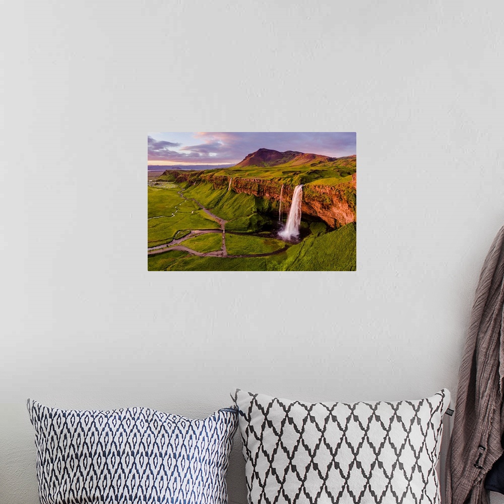A bohemian room featuring Aerial drone view of Seljalandsfoss waterfall at sunset, Iceland