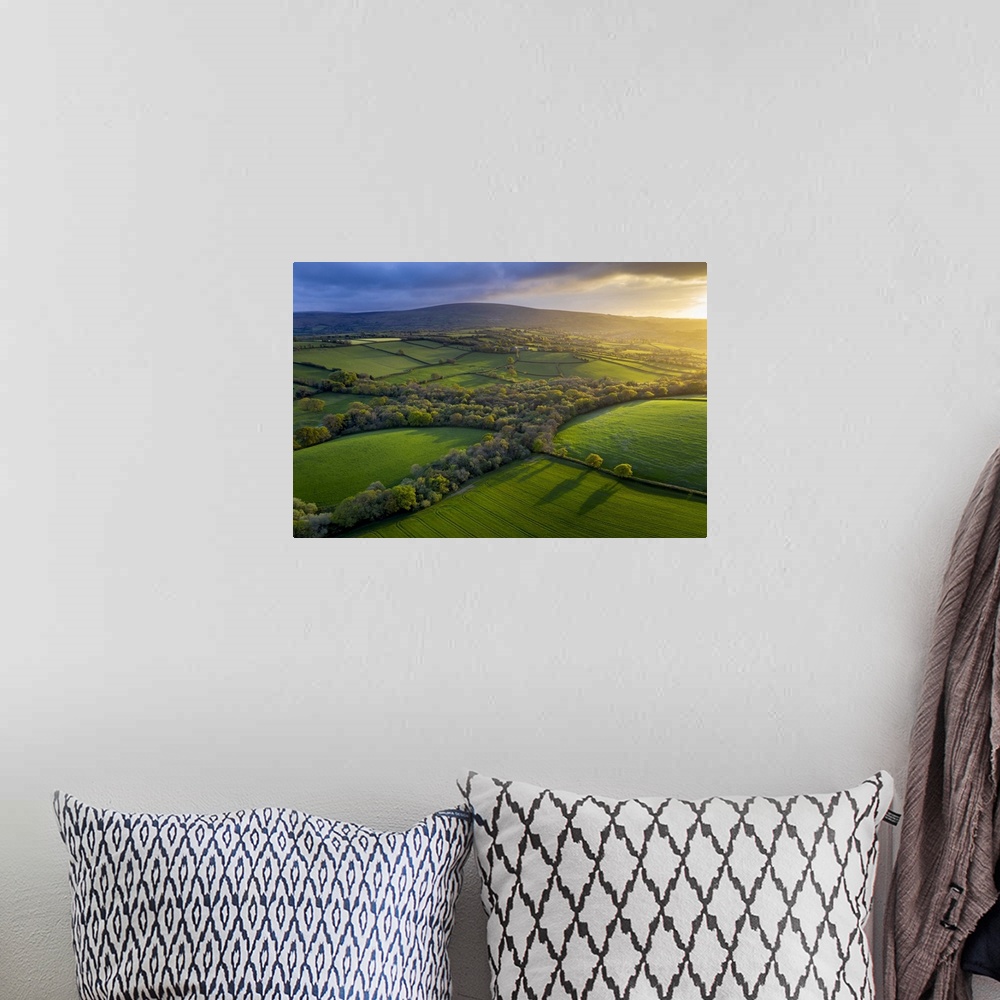 A bohemian room featuring Aerial photo of rolling countryside in evening light, Livaton, Devon, England. Spring (April) 2019.