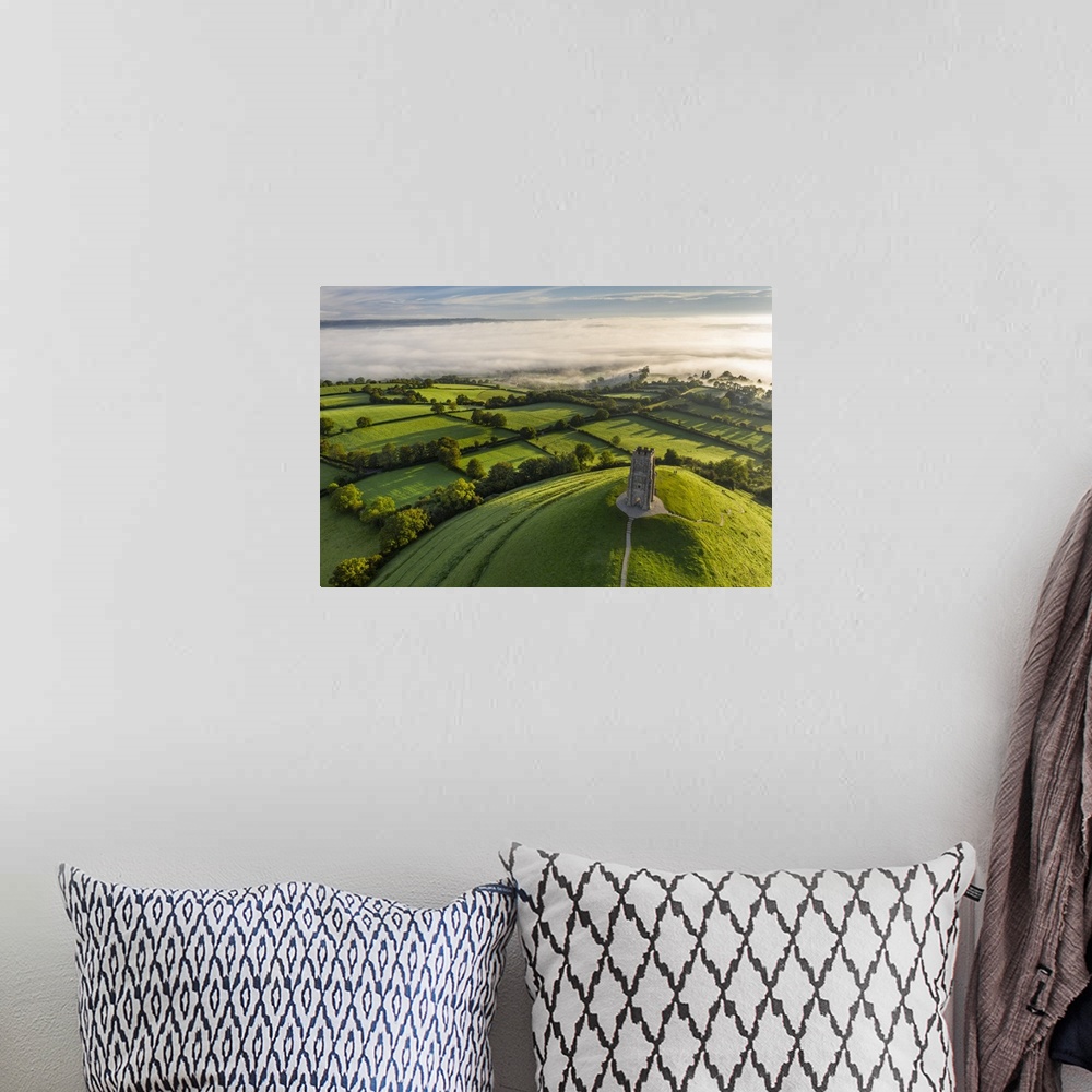 A bohemian room featuring Aerial view of St. Michael's Tower on Glastonbury Tor on a misty autumn morning, Somerset, Englan...