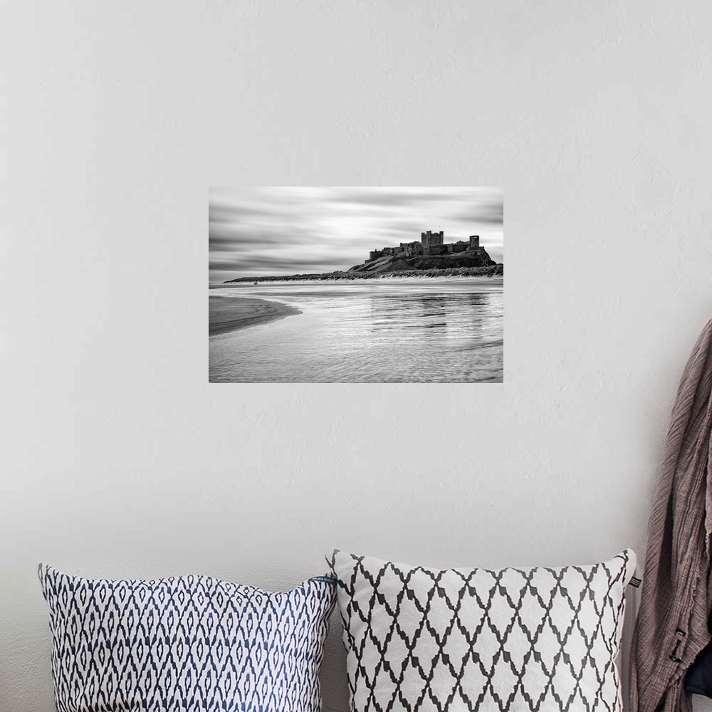 A bohemian room featuring Bamburgh castle and beach at low tide, Northumberland, UK