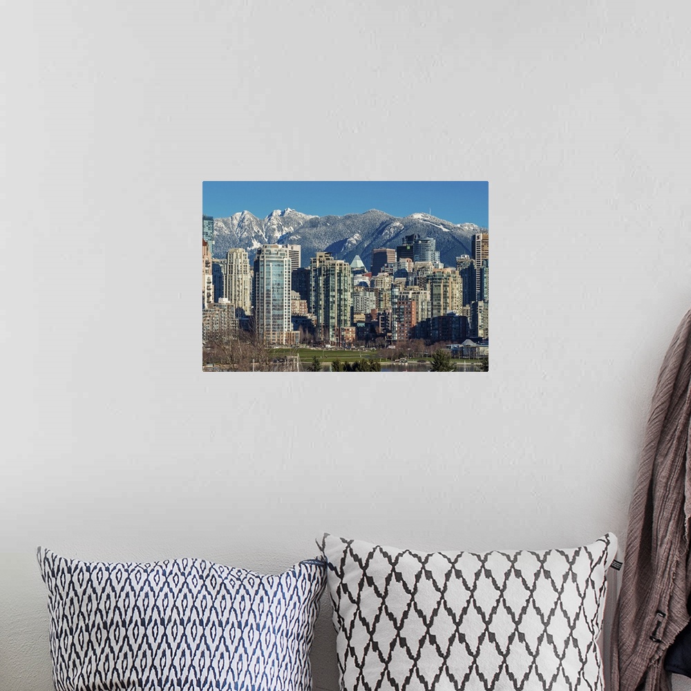 A bohemian room featuring Downtown skyline with snowy mountains behind, Vancouver, British Columbia, Canada.