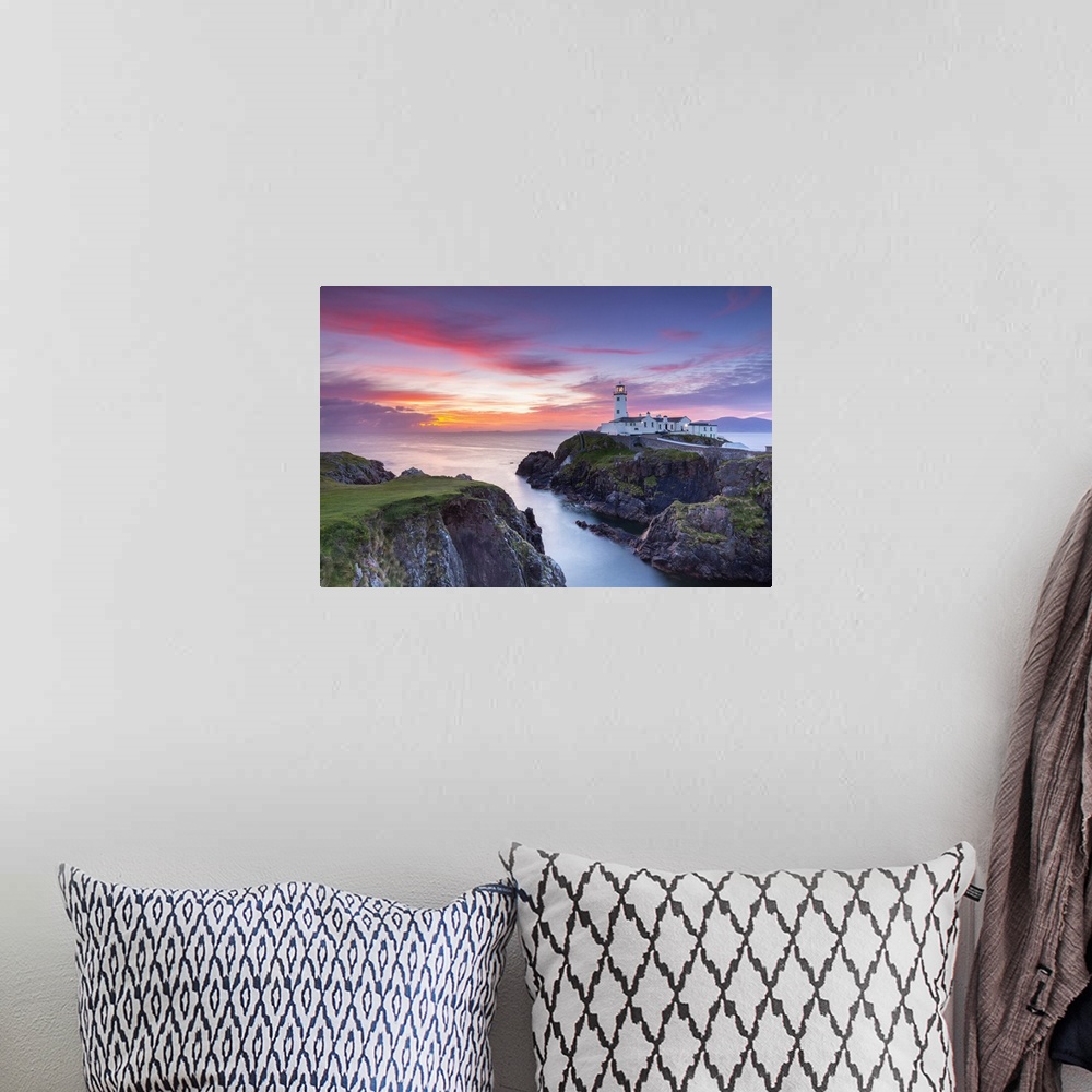 A bohemian room featuring Fanad Head lighthouse at sunrise, County Donegal, Ulster region, Ireland.