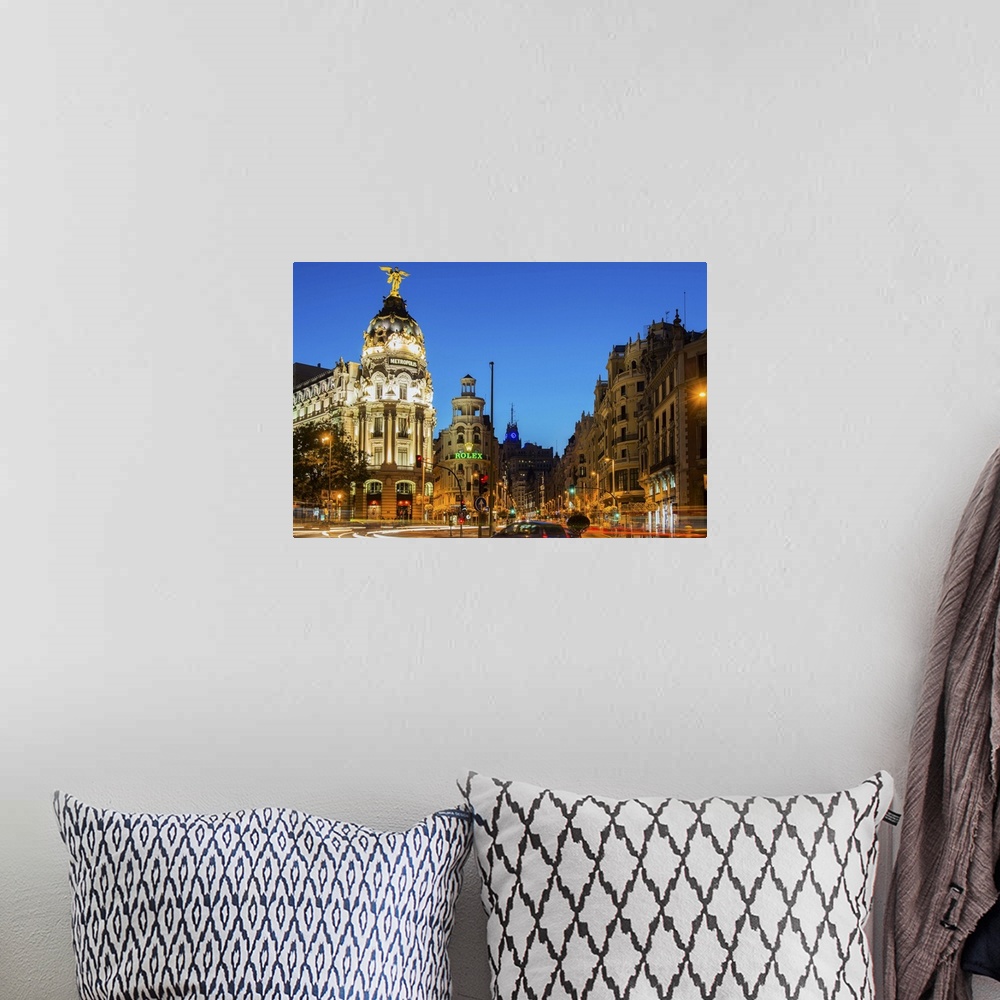 A bohemian room featuring Night view of Gran Via street and Metropolis Building with car light trails, Madrid, Comunidad de...