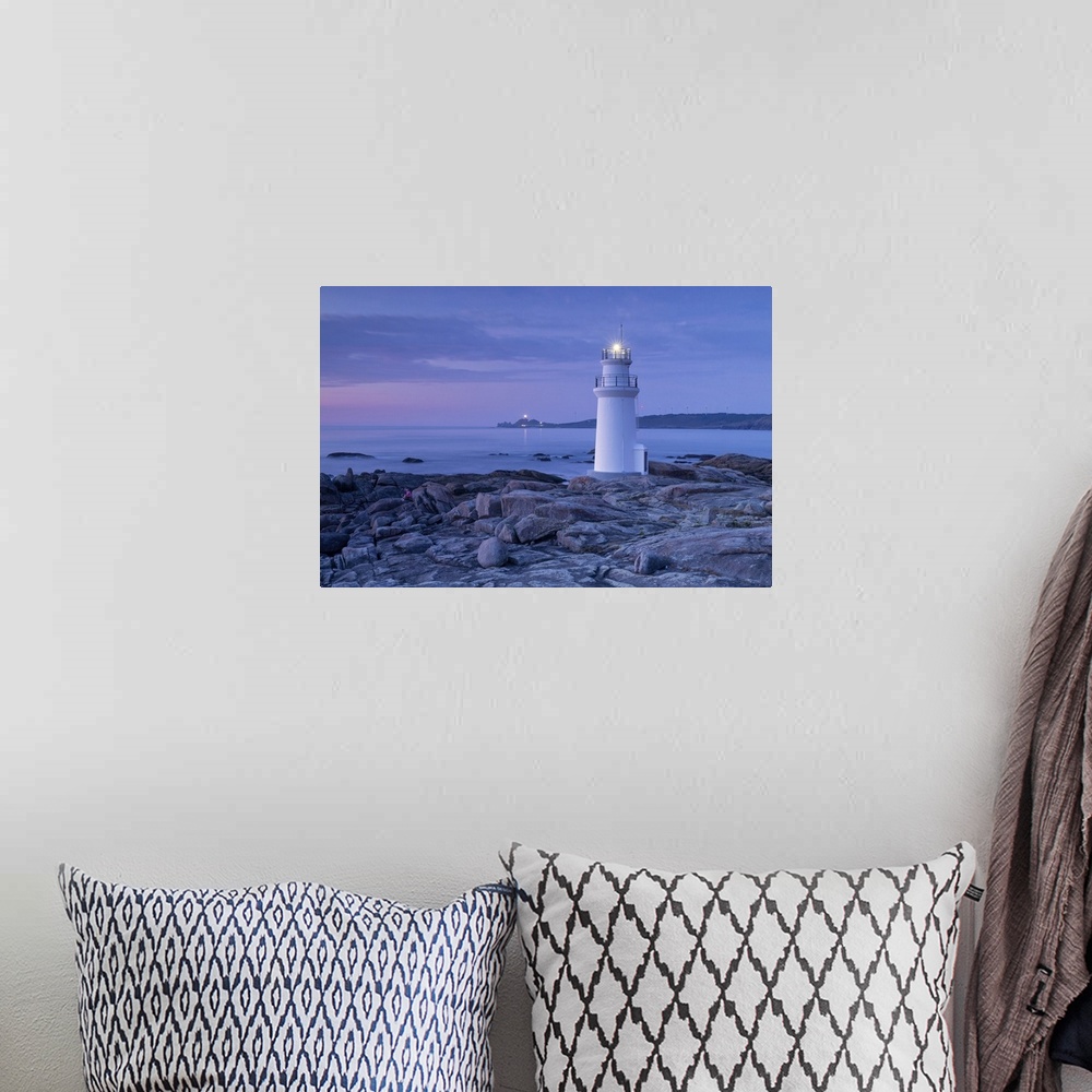 A bohemian room featuring Lighthouse of Muxia at dusk during a summer day, municipality of Muxia, Galicia, Spain.