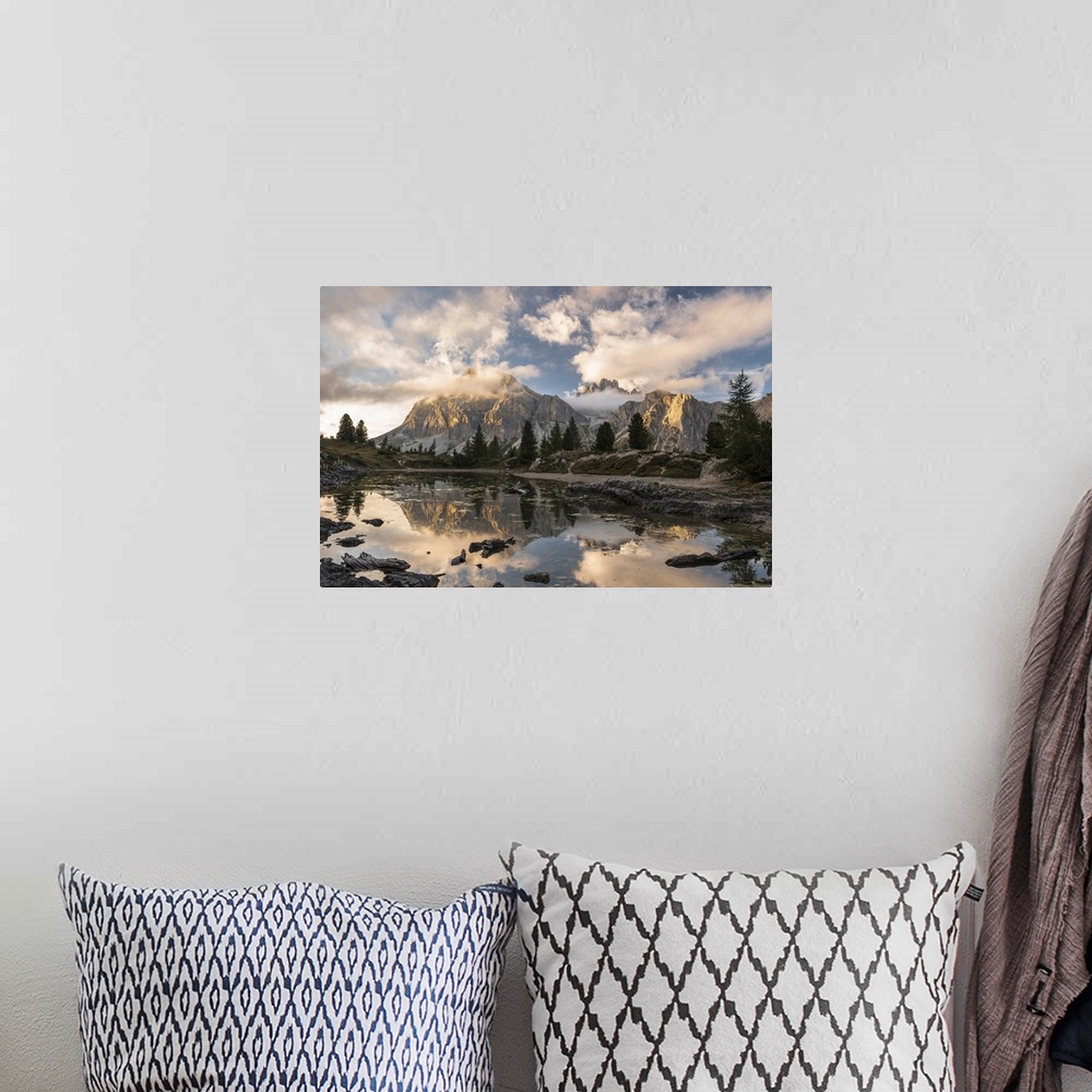 A bohemian room featuring Limides Lake at sunset with Lagazuoi on the background. Belluno, Veneto, Italy.