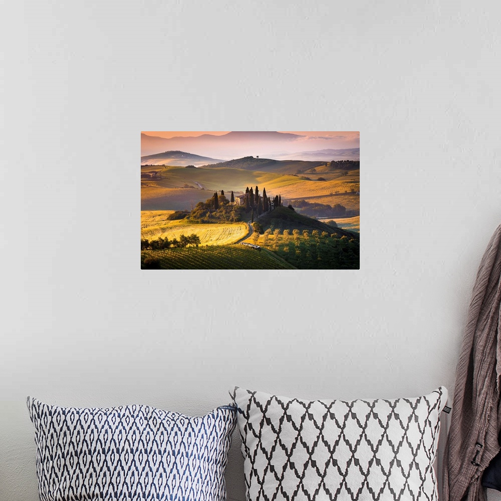 A bohemian room featuring Podere Belvedere, San Quirico d'Orcia, Tuscany, Italy. Sunrise over the farmhouse and the hills.