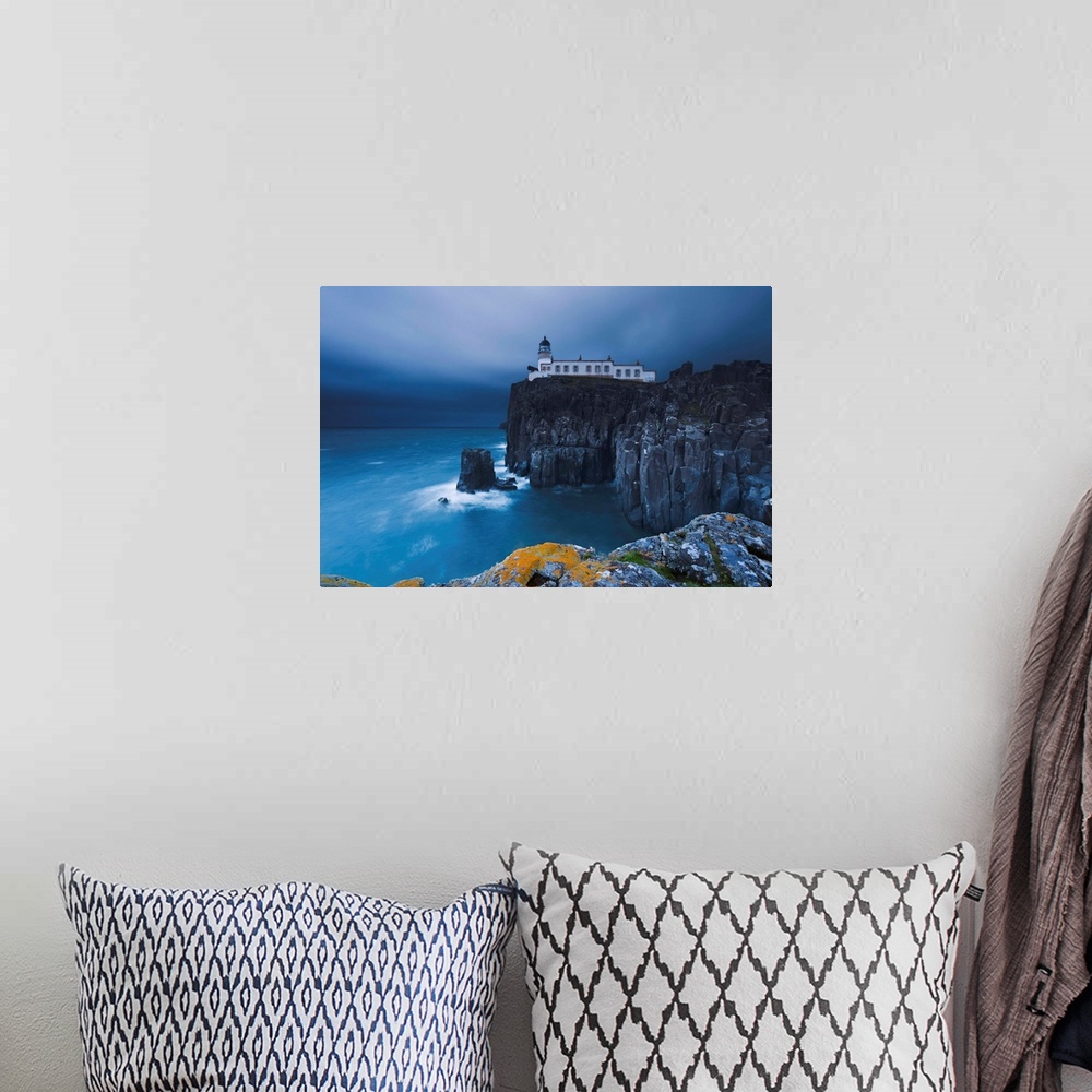 A bohemian room featuring Rocky cliff on the sea, with a lighthouse on the reef, Neist Point, Isle of Skye, Scotland, UK.