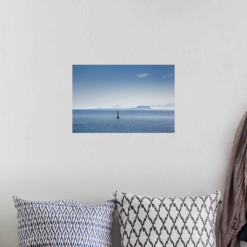 A bohemian room featuring Sailing boat and Fuerteventura, from Playa Blanca, Lanzarote, Canary Islands, Spain