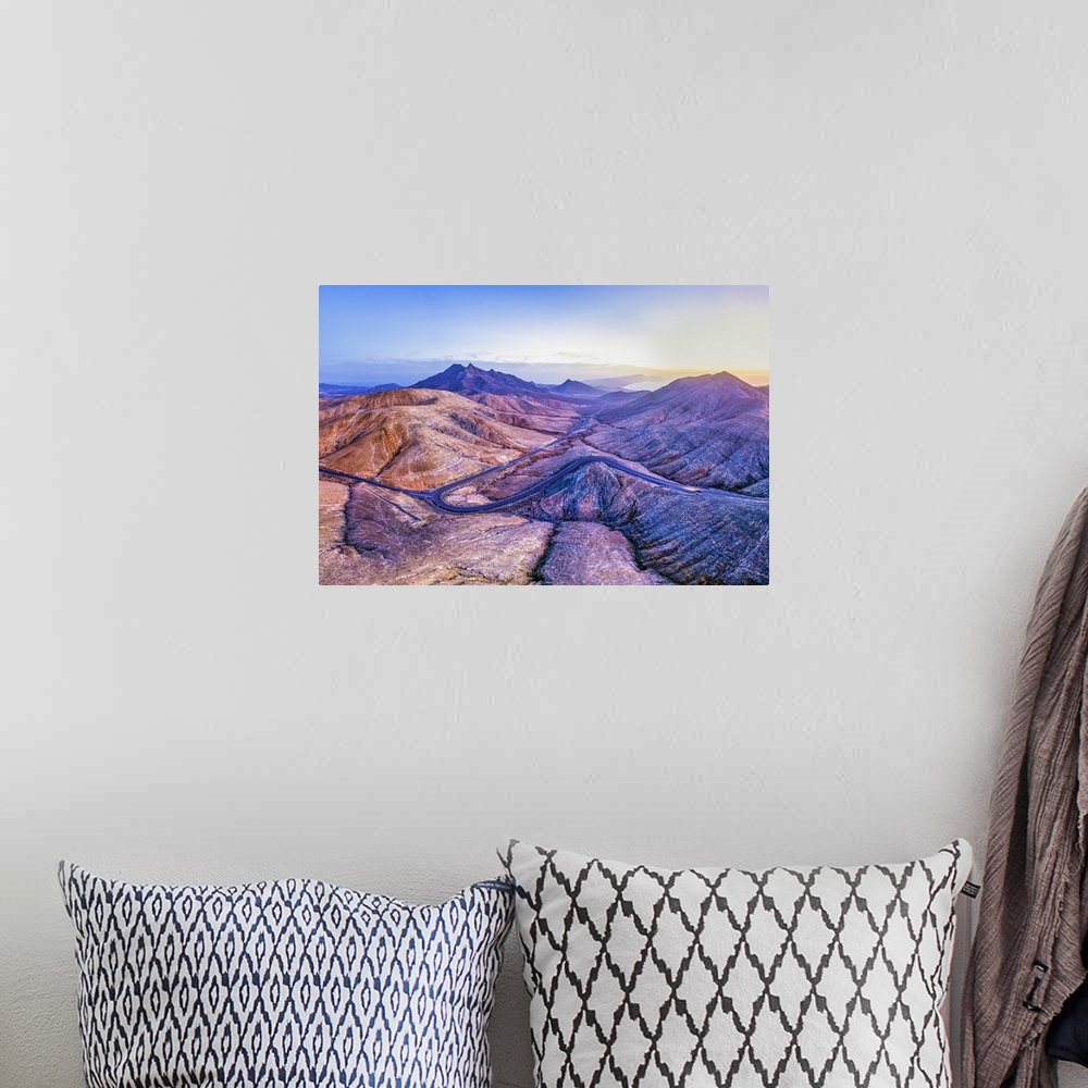 A bohemian room featuring Spain, Canary Islands, Fuerteventura, mountain road crossing the volcanic landscape near Sicasumb...