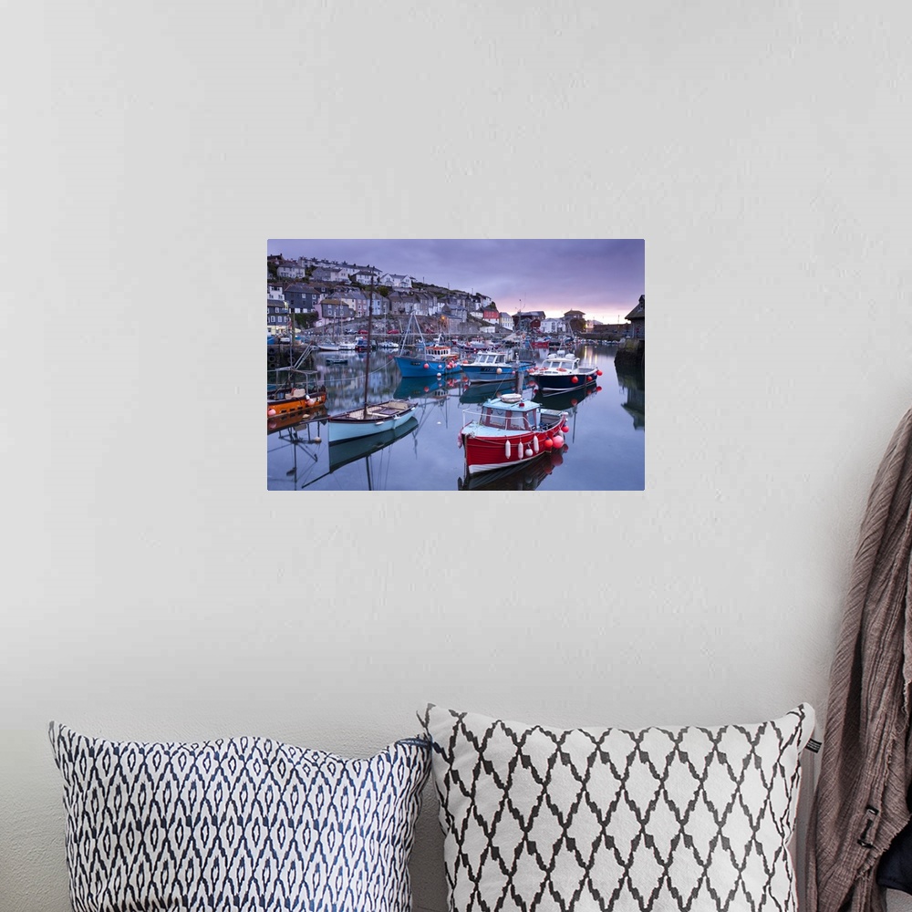 A bohemian room featuring Sunrise over the picturesque harbour at Mevagissey, Cornwall, England. Spring