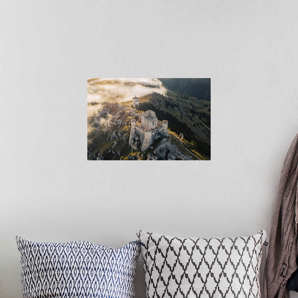 A bohemian room featuring Sunset in Rocca Calascio, an ancient building on the top of a mountain, Gran Sasso National Park,...