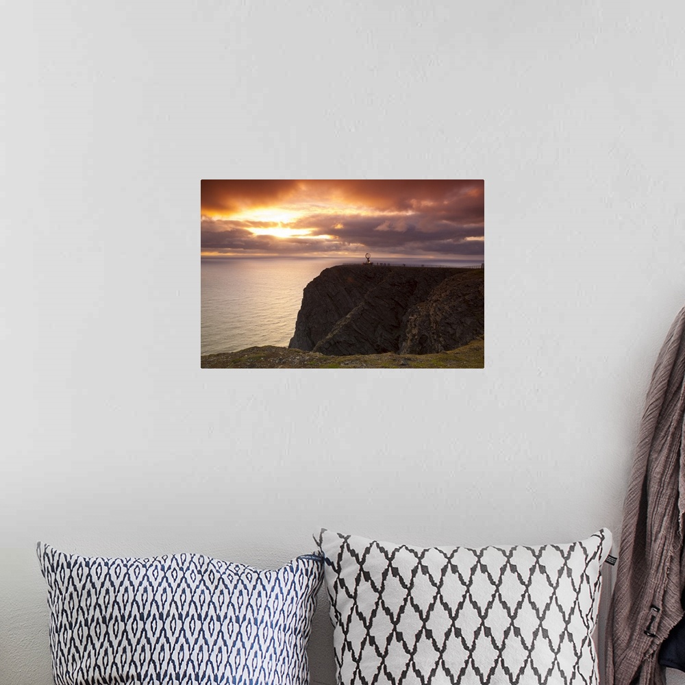 A bohemian room featuring The Midnight Sun breaks through the clouds at Nordkapp, Finnmark, Norway