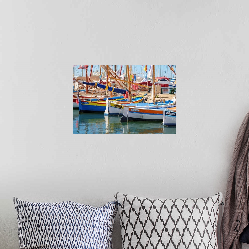 A bohemian room featuring Traditional colorful wooden fishing boat in the port harbor at Sanary-sur-Mer, Var department, Pr...