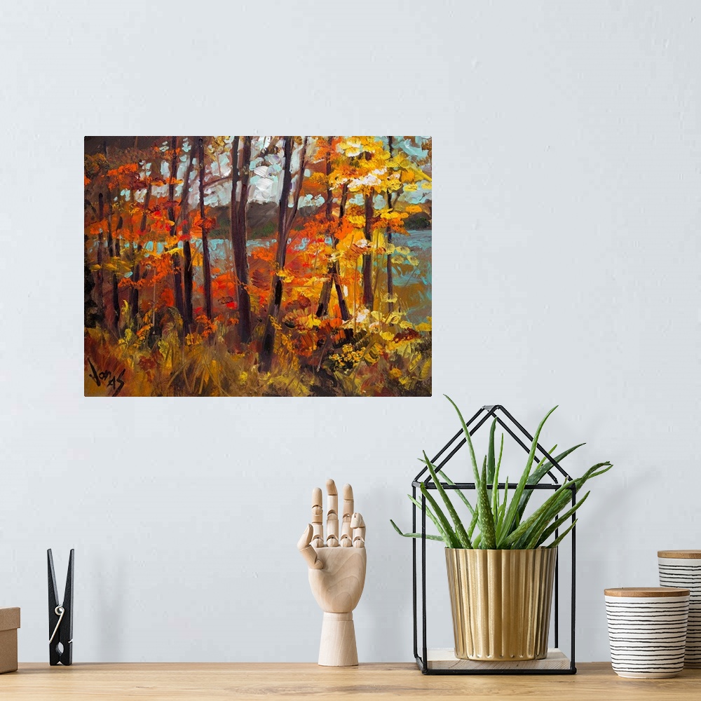 A bohemian room featuring Large, horizontal painting of fall colored trees creating a wall in front of a lake in the backgr...