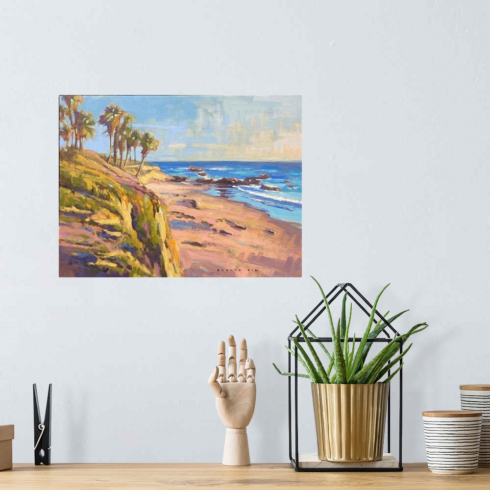 A bohemian room featuring A contemporary impressionist painting of palm trees and a rocky coastline as the sun sets