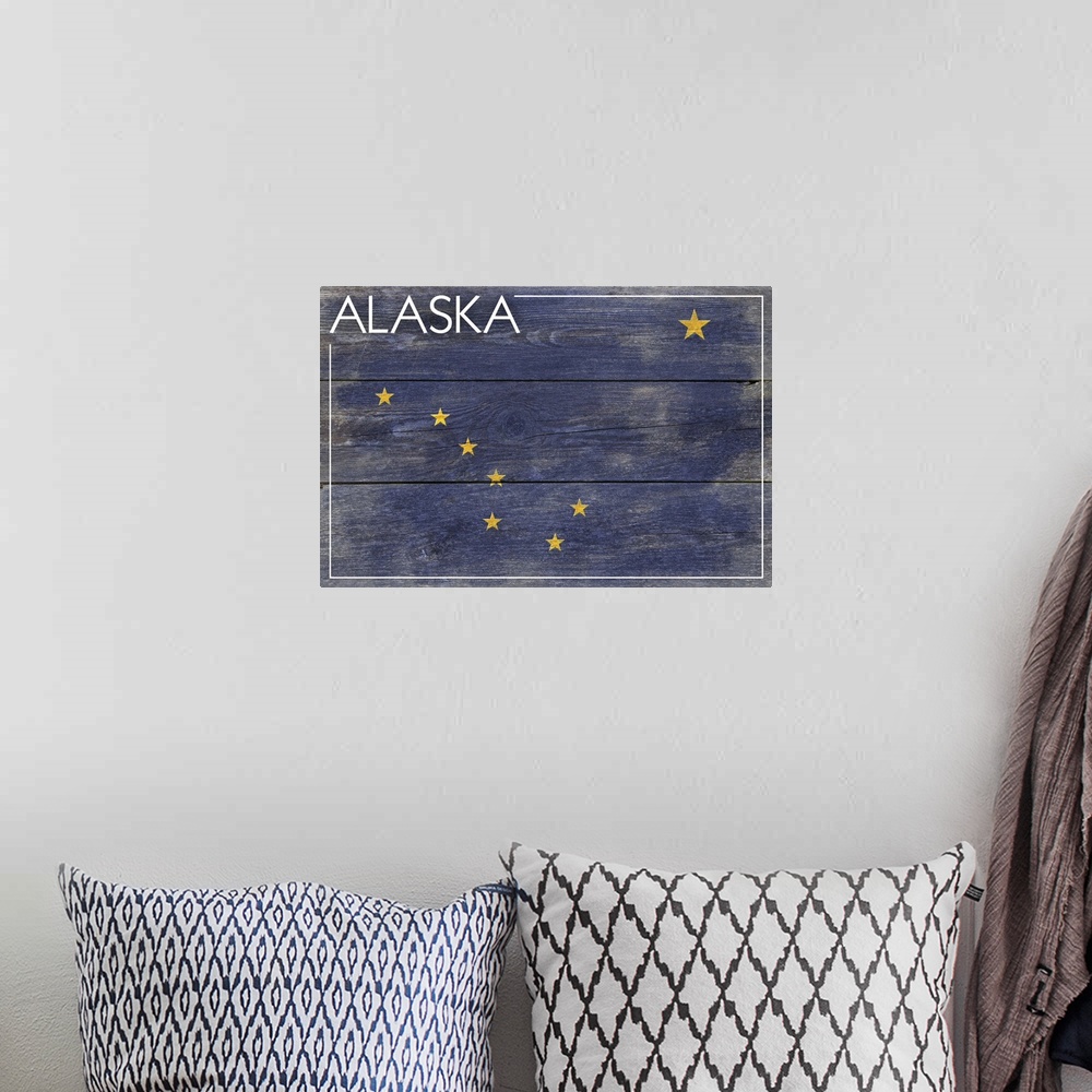 A bohemian room featuring The flag of Alaska with a weathered wooden board effect.